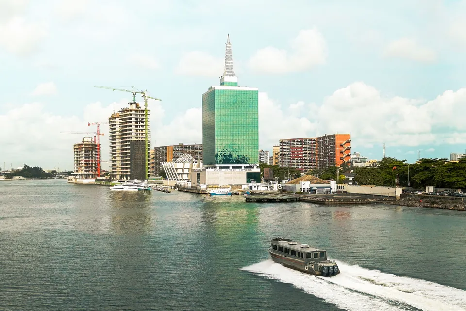 An elevated view of civic road and rail infrastructure threading through Lagos, Nigeria.