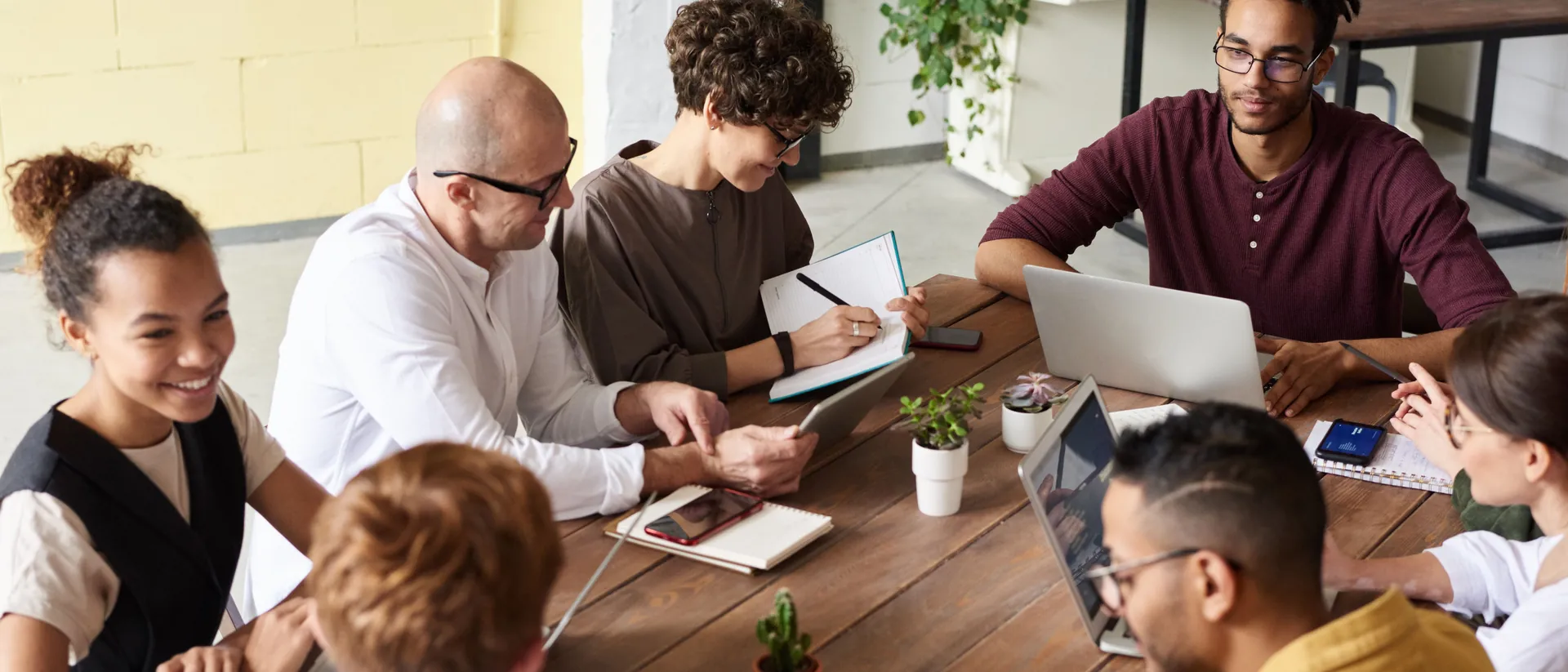 A small group gathered around a table, in conversation