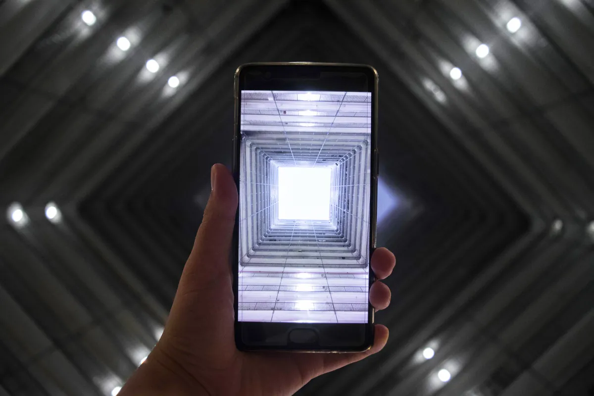 A phone held toward a bright opening